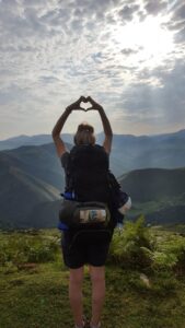 Pilgrim making a heart with her hands